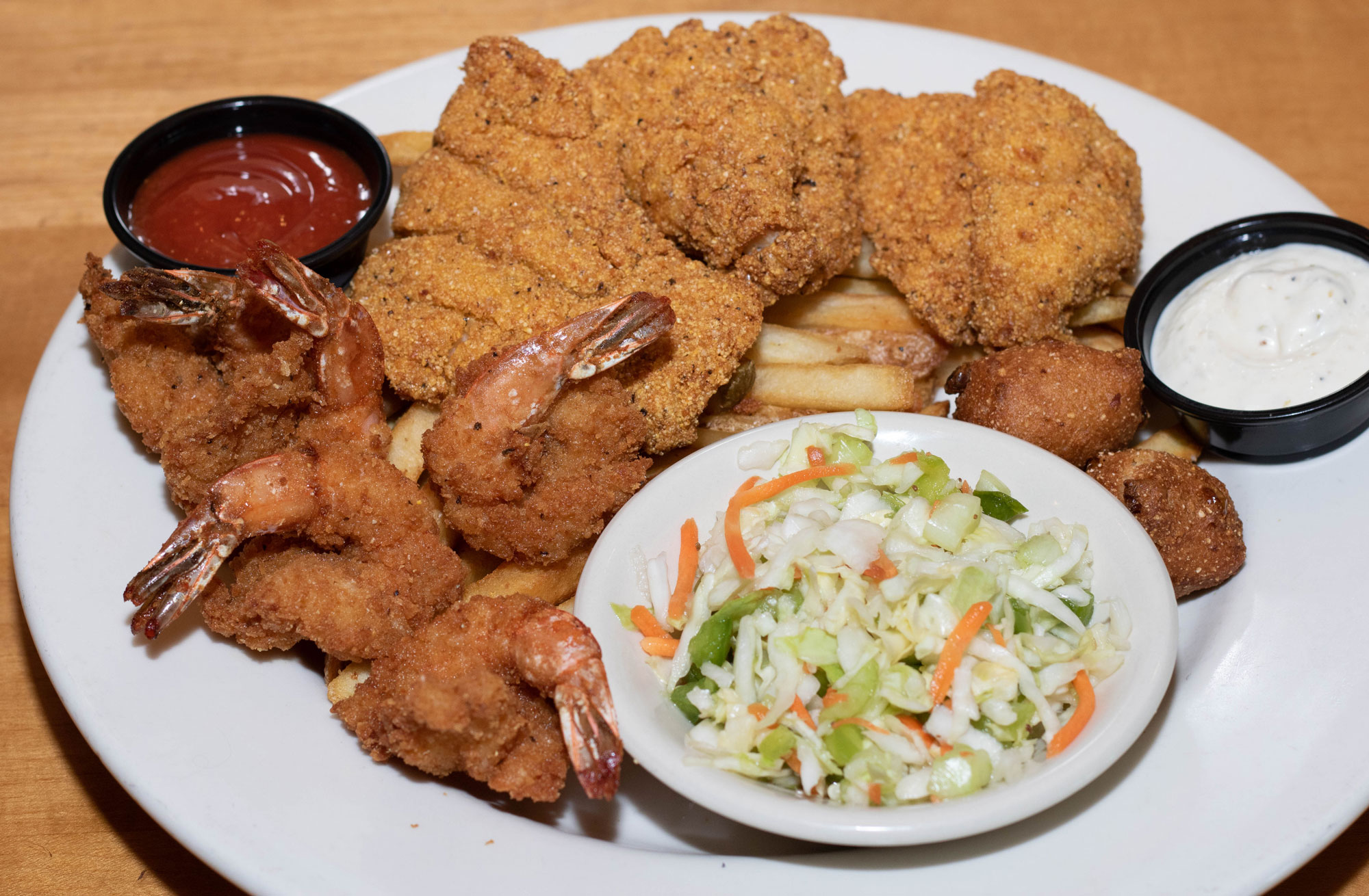 3 pieces of U.S. farmed catfish and 5 large shrimp with cocktail & tartar sauce. Served with crispy french fries, apple cider slaw, and our jalapeno hush puppies.