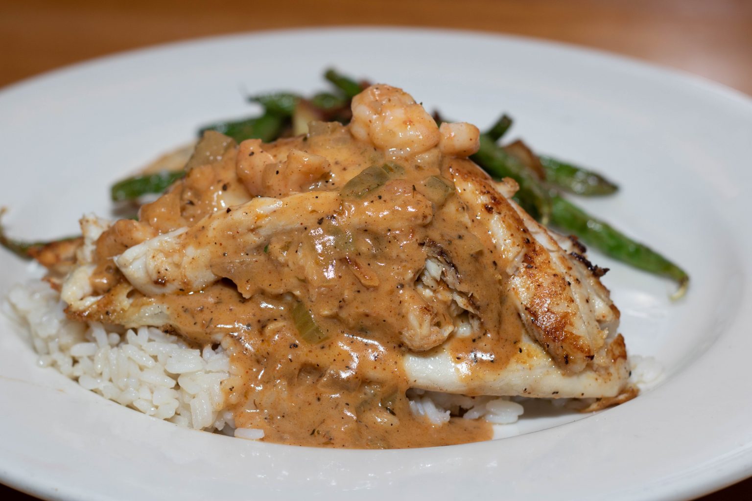 Jumbo lump crab cake stuffed in a blackened tilapia with shrimp etouffee, rockin' green beans & rice