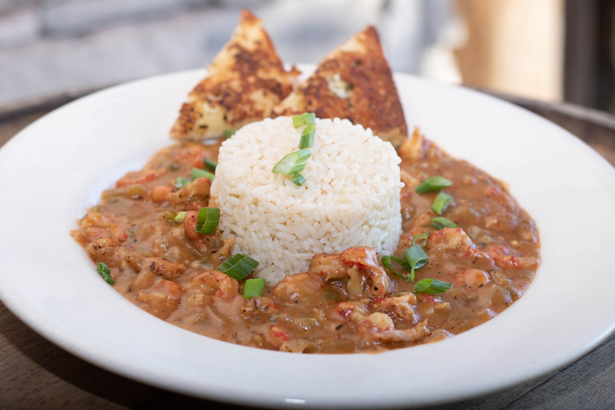 Plump crawfish tails in our spicy from scratch etouffee with white rice and a side of toasted garlic bread