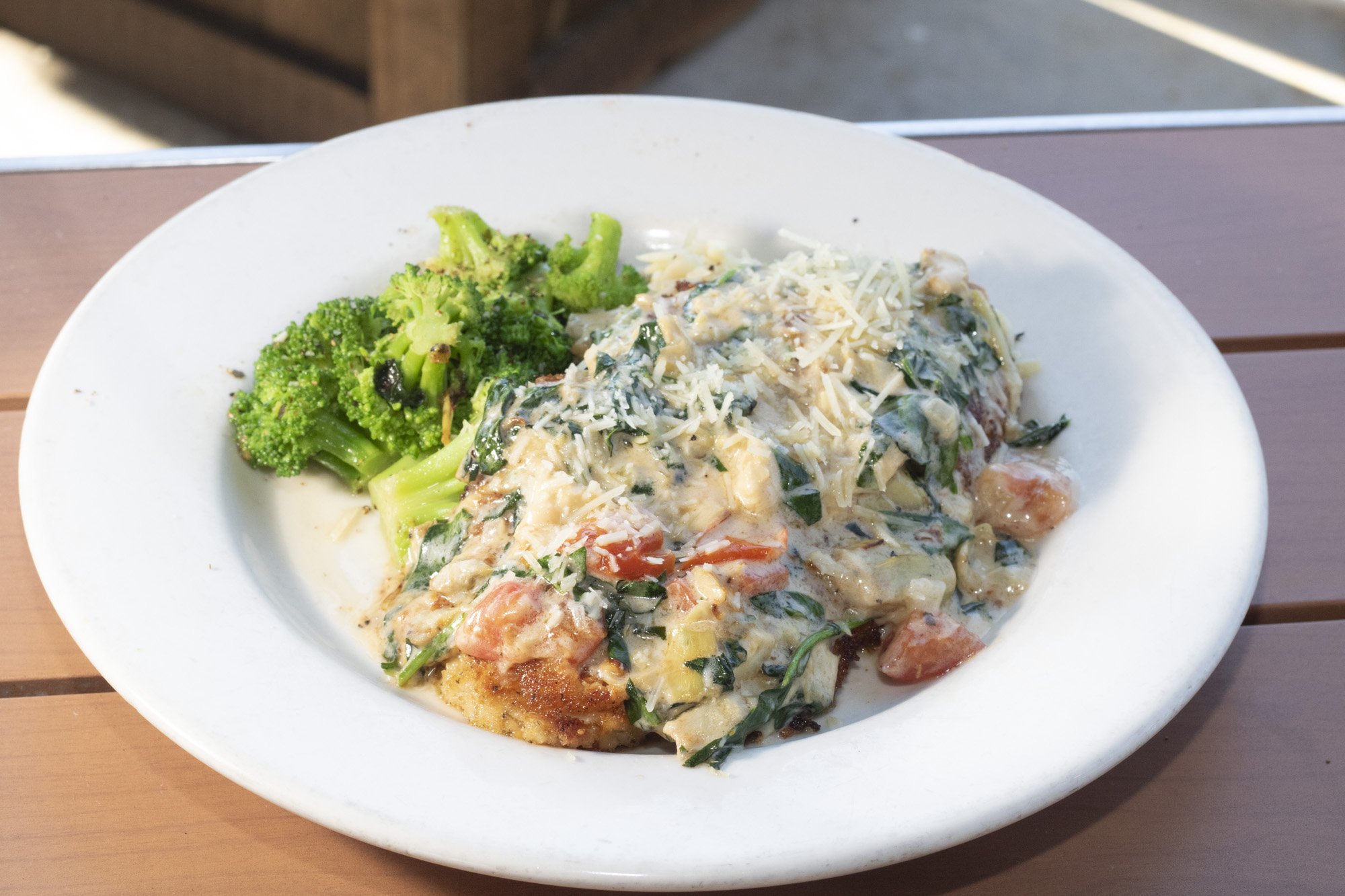 Chicken breast crusted with our homemade herb parmesan breading and smothered with tomatoes, spinach, artichokes, and white wine lemon butter, served with herbed orzo and sauteed broccoli