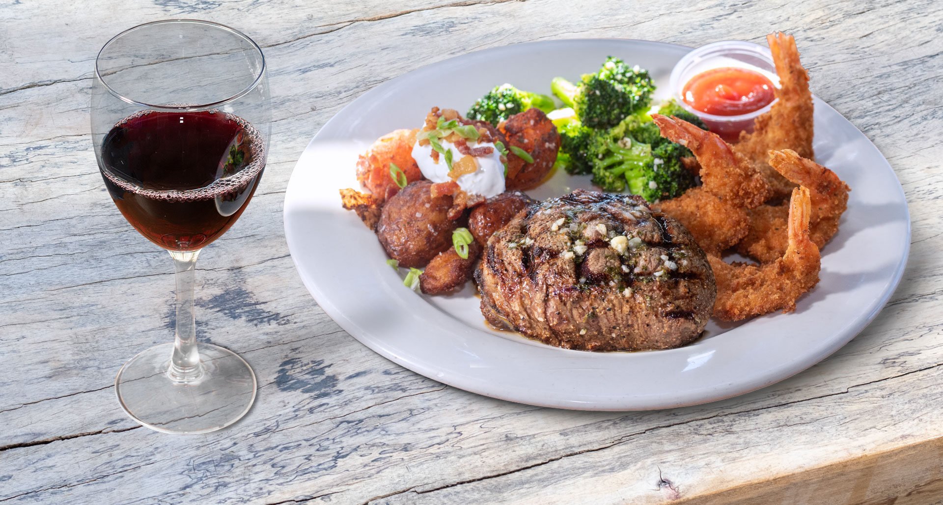 Your choice of 4 large shrimp or a jumbo lump crab cake with an 8 oz center-cut certified angus beef sirloin topped with garlic butter and served with loaded red potatoes and sauteed broccoli.