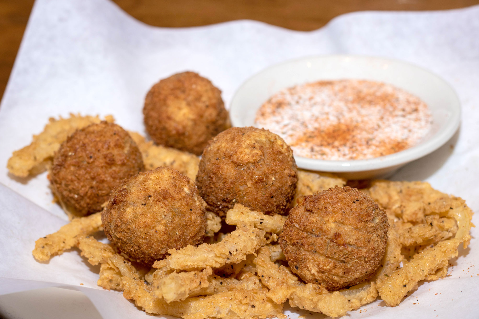 Stuffed fritters filled with shrimp, cheddar-jack cheese, jalapeños, bacon, and green onions. Cheesy, melty deliciousness jam-packed with flavor