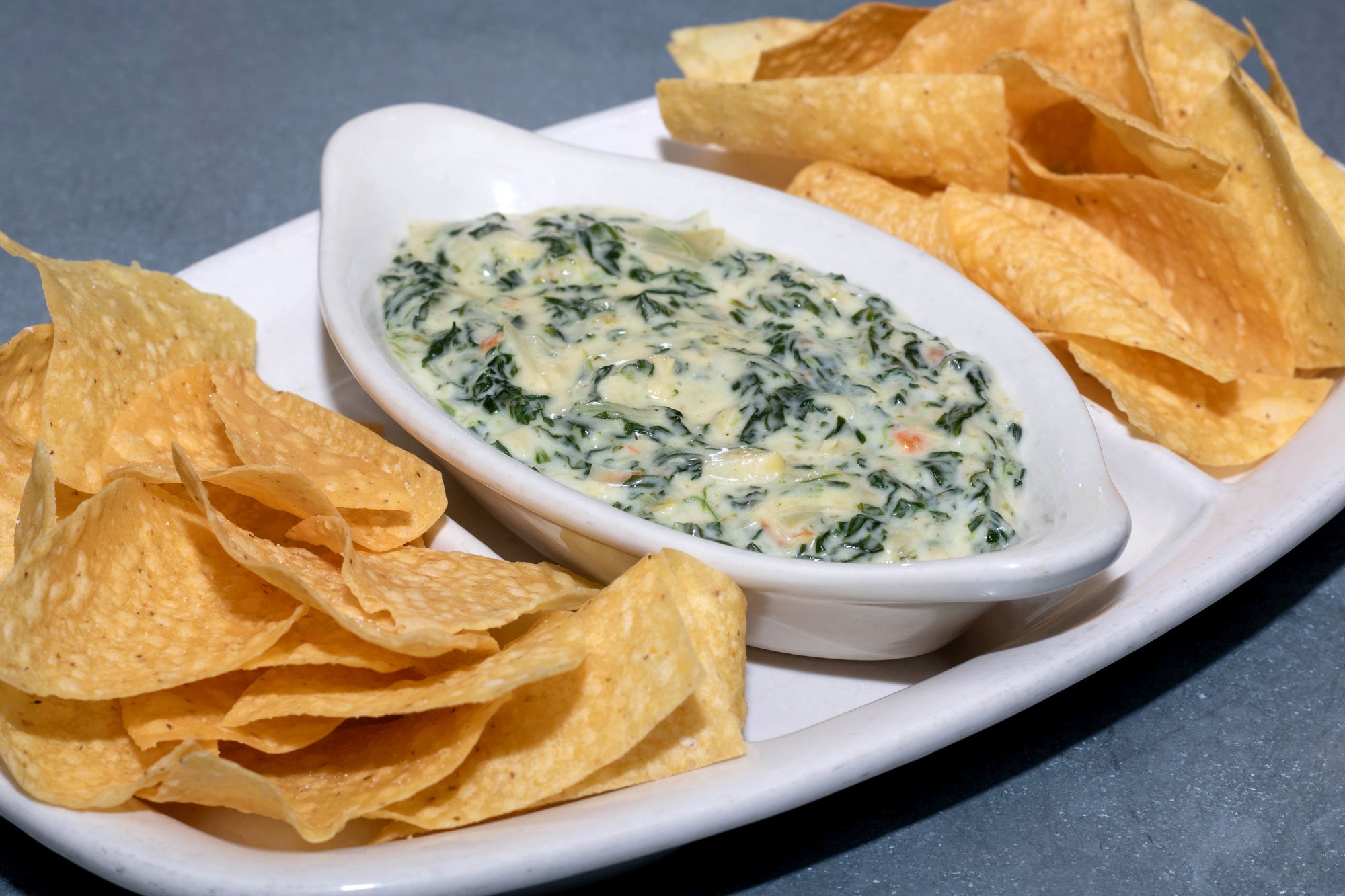 Melted Parmesan, Romano, and white American cheese with sauteed spinach and artichoke hearts. Served with fresh fried tortilla chips.