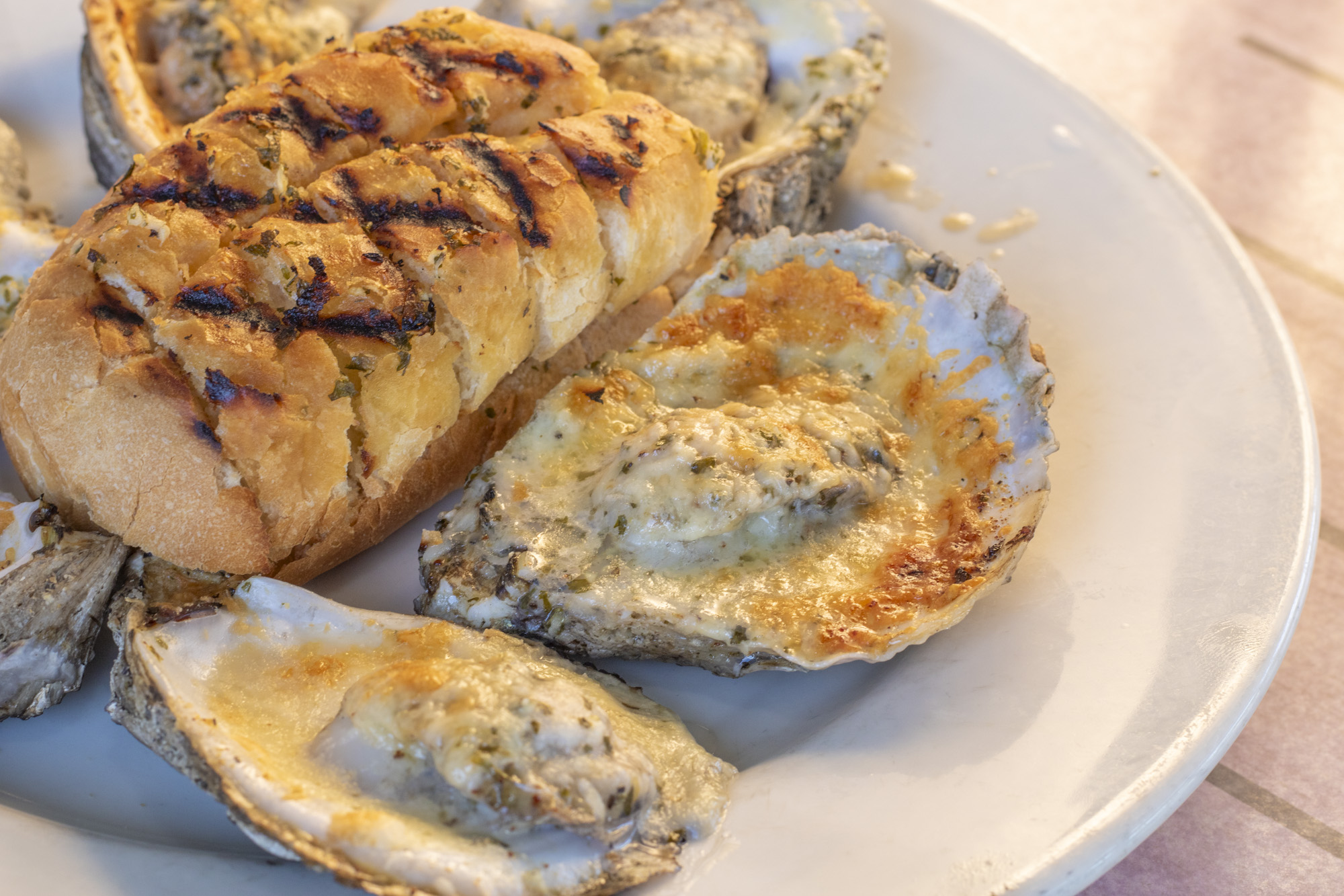 Half dozen freshly shucked oysters chargrilled with garlic butter and parmesan cheese. Served with grilled bread.