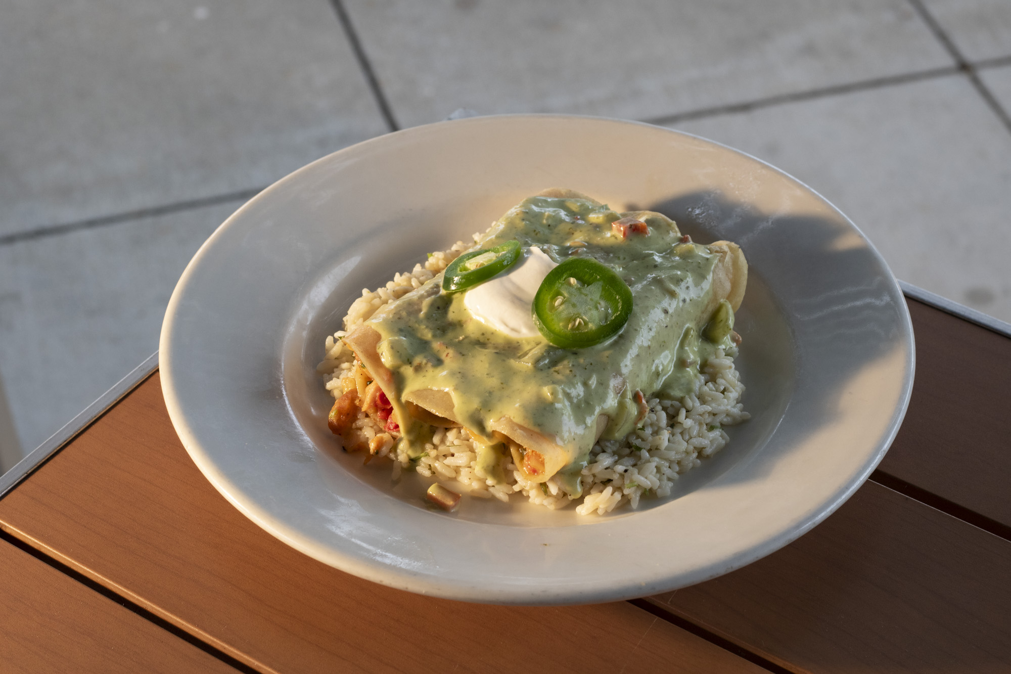 3 enchiladas with shrimp, salmon, and cheddar-jack topped with jalapeno cream, sour cream, with cilantro lime rice