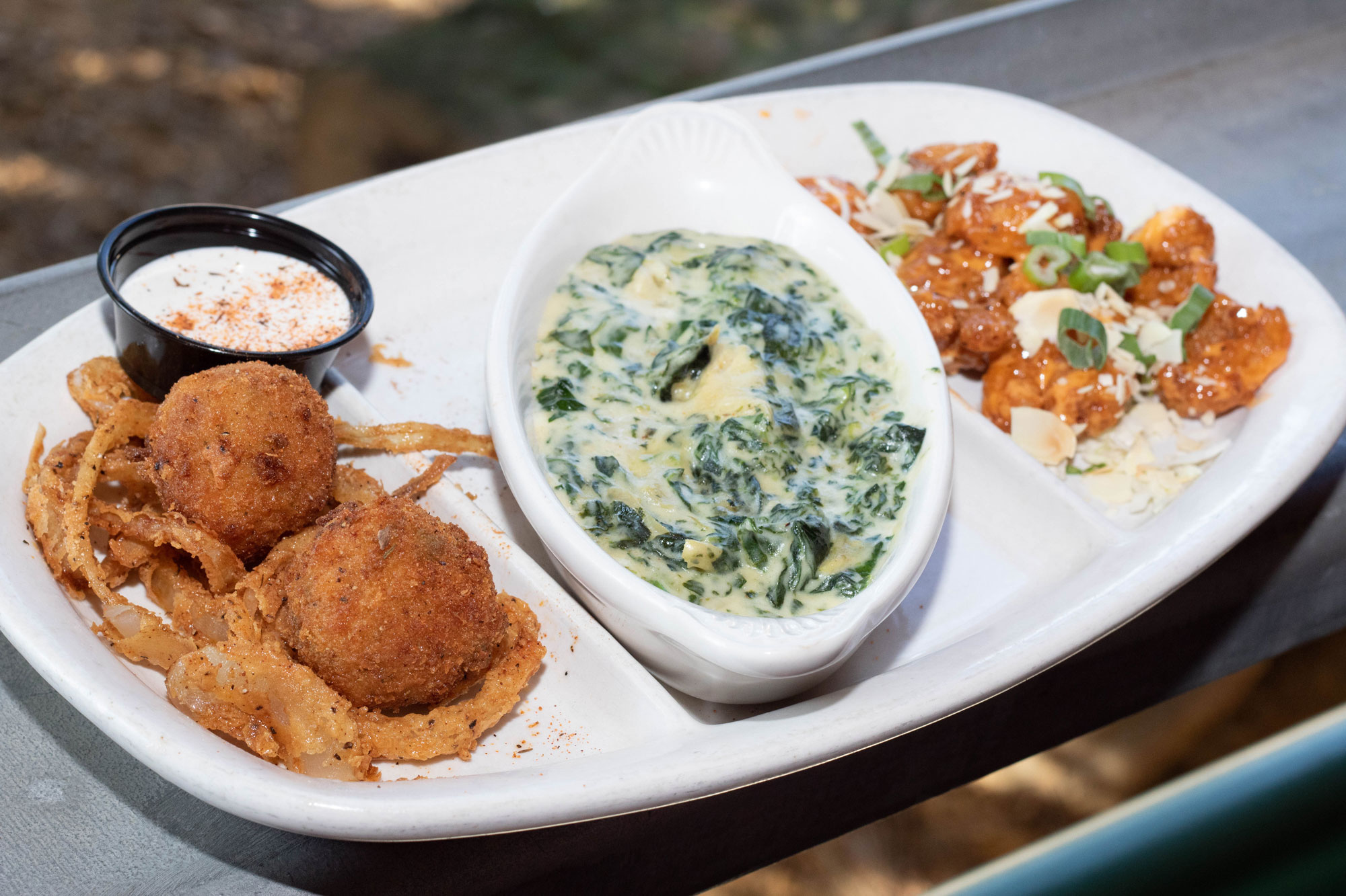 Large platter filled with fried bombs, spinach and artichoke dip, and volcano shrimp