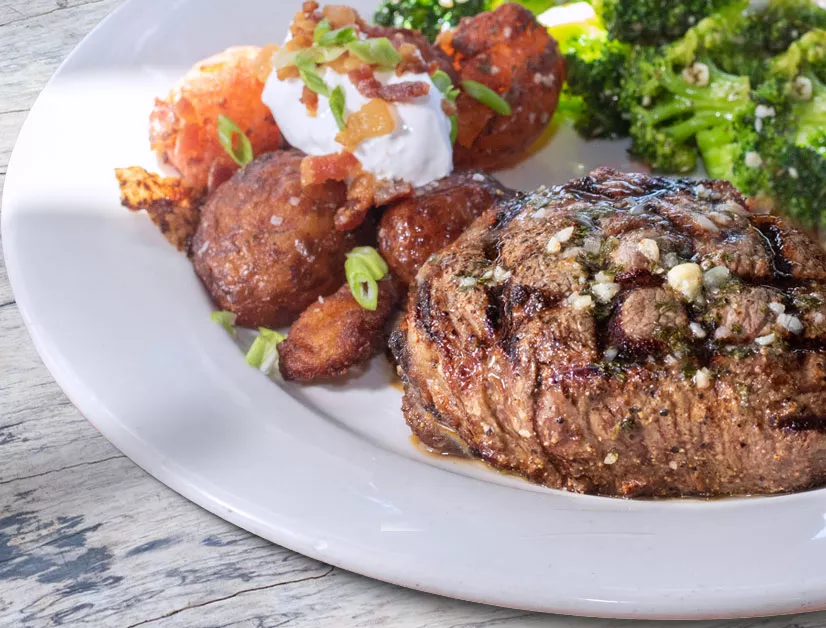 8 oz center-cut, certified angus beef sirloin topped with garlic butter, and served with loaded red potatoes and broccoli