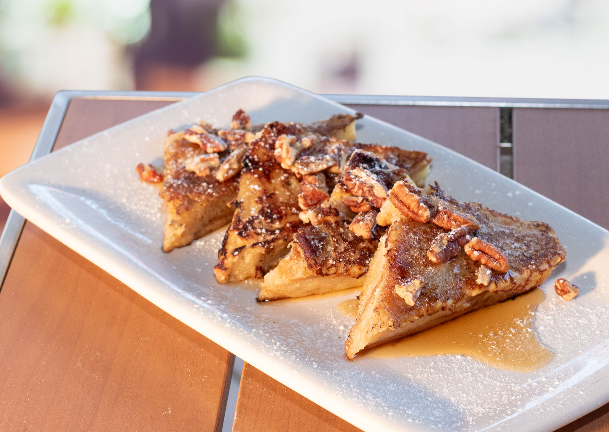 Our famous croissant bread pudding soaked in french toast batter and pan-fried. Topped with pecans and maple syrup