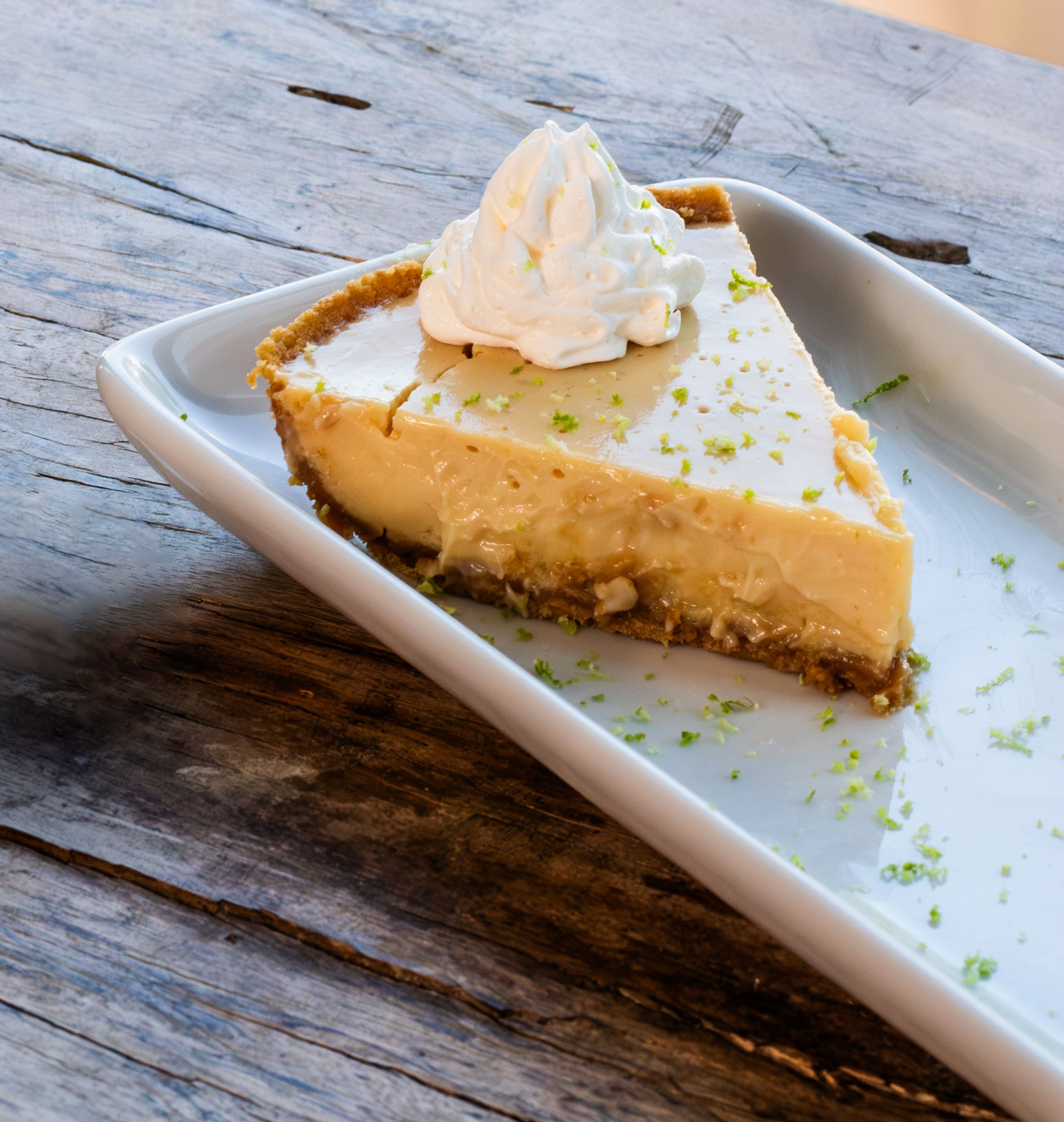 Rich and creamy homemade key lime pie topped with whipped cream