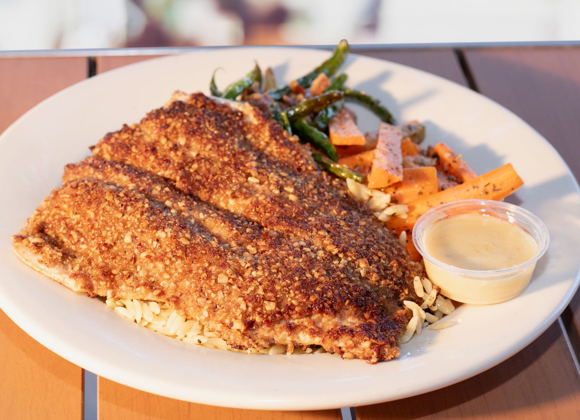 Pecan crusted and served with our white wine lemon butter on herb orzo pasta