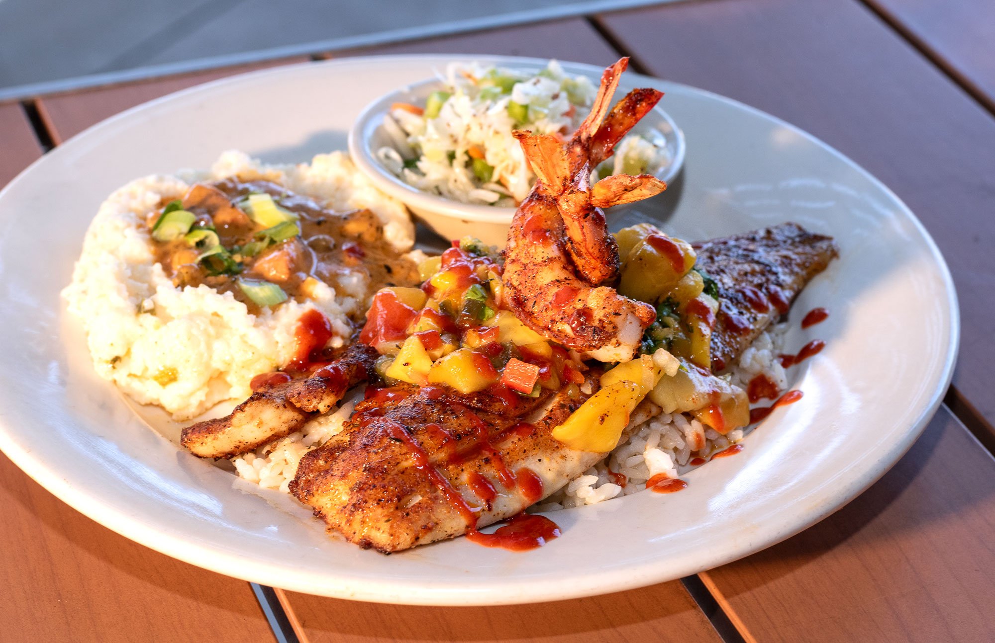 Blackened, with two large grilled shrimp, mango salsa, and a sriracha drizzle on rice