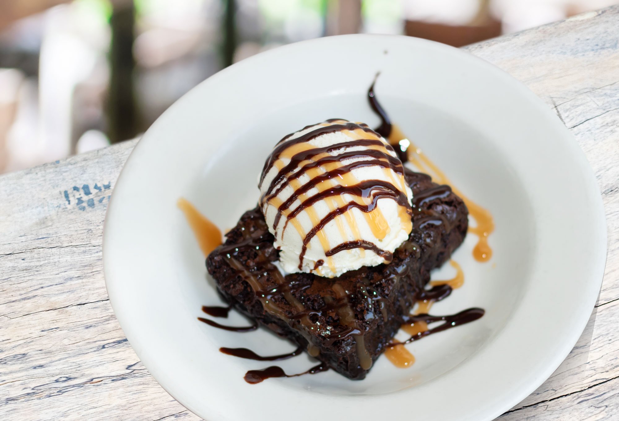 Ghirardelli triple chocolate brownie with vanilla ice cream, Hershey's chocolate syrup and Smuckers caramel sauce