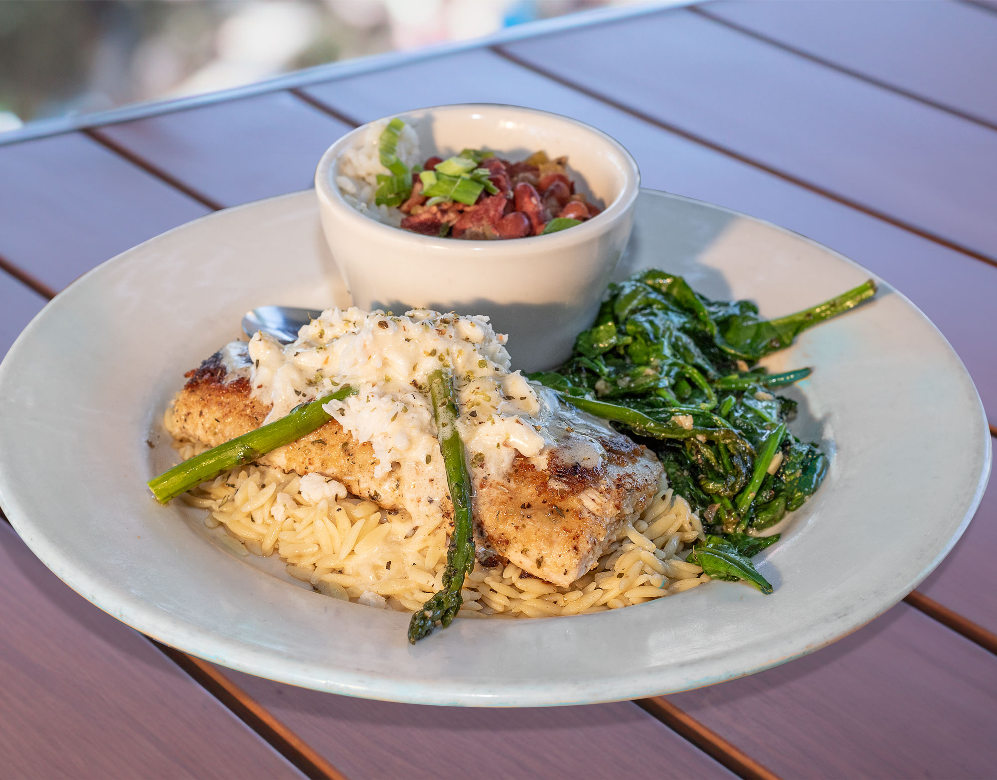 Herb Parmesan crusted with lump crab, white wine basil lemon butter & asparagus on herb orzo pasta